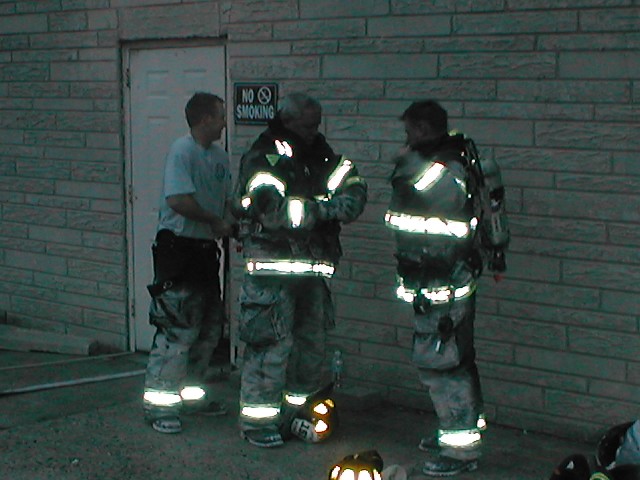 5/23/2005: FF Jim Bresch helps Capt. Jim Moore and Eng. Ernie Kozarski with their air packs.