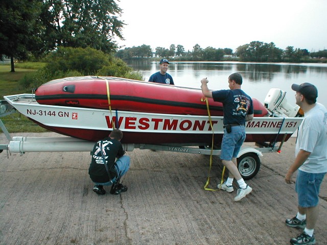 Eng. Callahan and Lts. Young and Settles prepare to place the boats in the water.